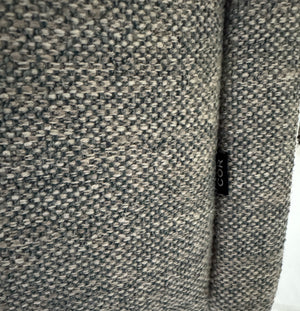 Gebrauchtes graues Stoffsofa mit einem Hocker von COR Modell Avalanche vor einer modernen Wand.