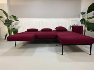 Gebrauchtes Brühl Roro Soft Designer Stoff Ecksofa in der Farbe Rot vor einer Wand, stilvoll und modern eingerichtet.