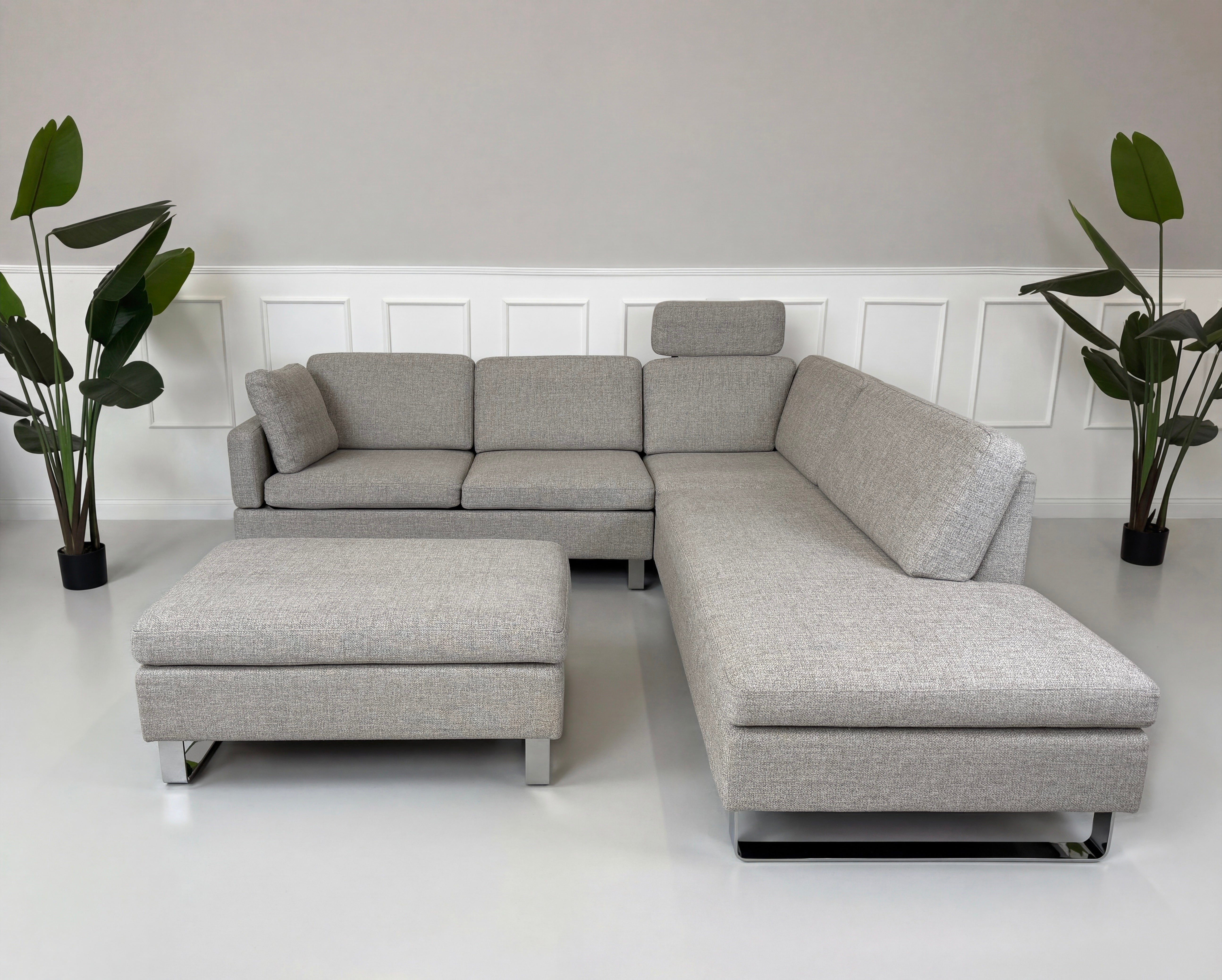 Gebrauchtes graues Brühl Alba Designer Stoff Sofa vor einer Wand, stilvoll und modern eingerichtet