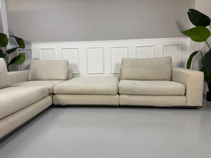 Gebrauchtes beiges Minotti Hamilton Designer Stoff Sofa vor einer Wand, stilvoll und modern eingerichtet