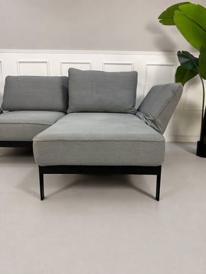 Gebrauchtes graues Rolf Benz Mera Designer Stoff Sofa vor einer Wand, stilvoll und modern eingerichtet.