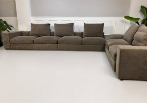 Gebrauchtes braunes Flexform Groundpiece Designer Stoff Sofa vor einer Wand, stilvoll und modern eingerichtet.