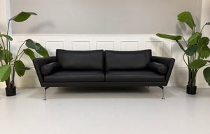 Gebrauchtes schwarzes Vitra Suita Designer Leder Sofa 3 Sitzer frontal vor einer Wand, stilvoll und modern eingerichtet.