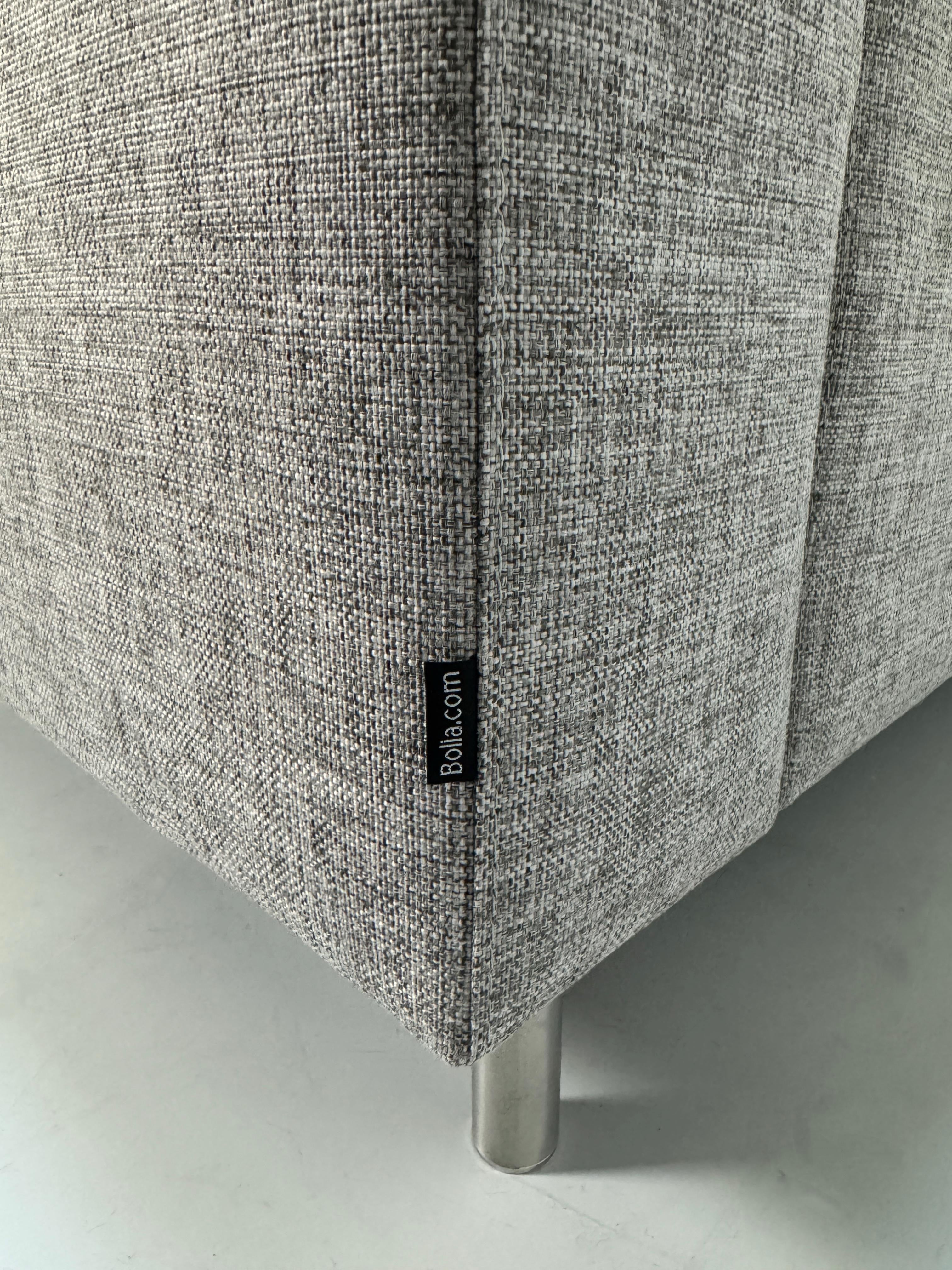 Gebrauchtes graues Bolia Scandinavia Designer Stoff Sofa mit Metallfüßen vor einer Wand, stilvoll und modern eingerichtet.