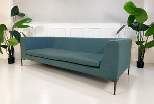 Gebrauchtes blaues B&B Italia Charles Designer Stoff Sofa vor einer Wand, stilvoll und modern eingerichtet.