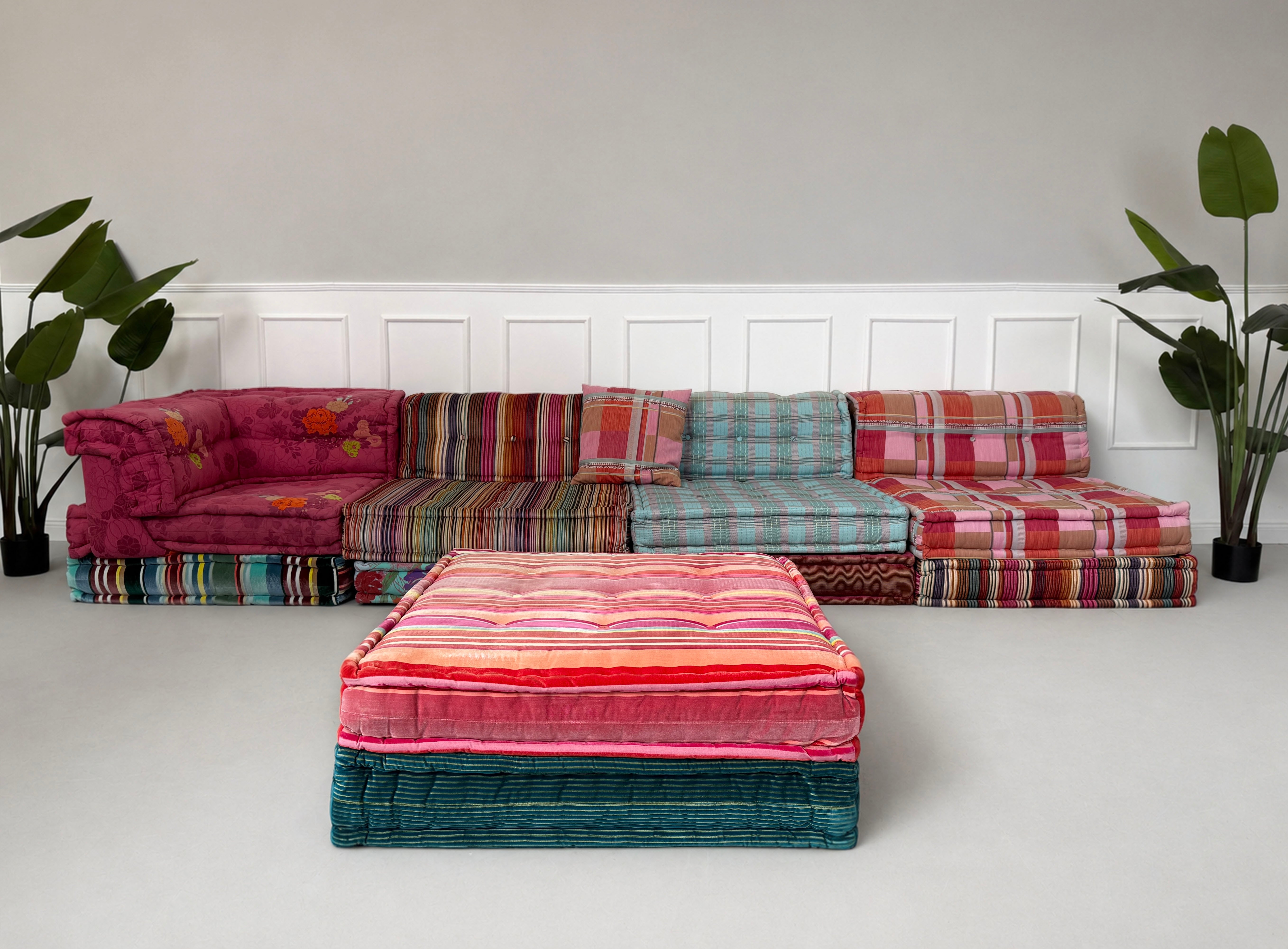 Gebrauchtes buntes Roche Bobois Mah Jong Designer Stoff Sofa vor einer Wand, stilvoll und modern eingerichtet.