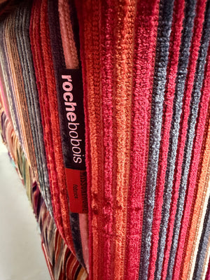 Gebrauchtes buntes Roche Bobois Mah Jong Designer Stoff Sofa vor einer Wand, stilvoll und modern eingerichtet.