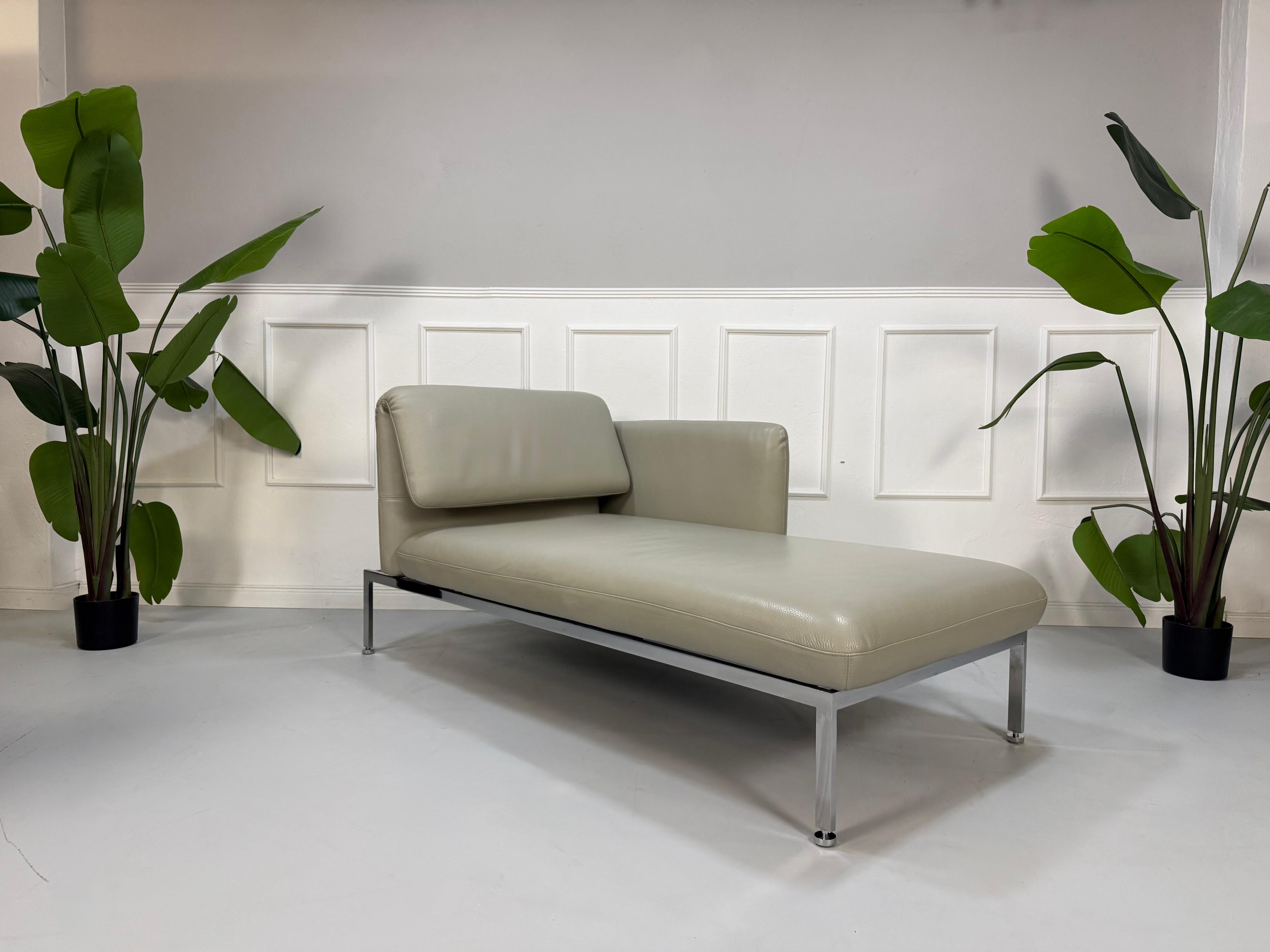 Gebrauchte graue Brühl Roro Designer Chaiselounge vor einer Wand, stilvoll und modern eingerichtet.