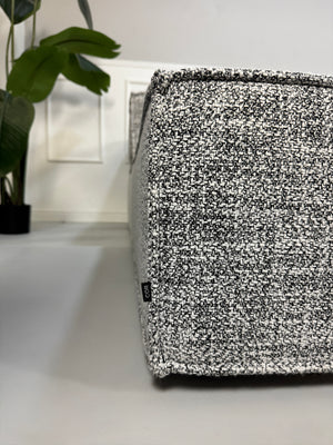 Gebrauchtes graues COR Trio Designer Stoff Sofa vor einer Wand, stilvoll und modern eingerichtet.