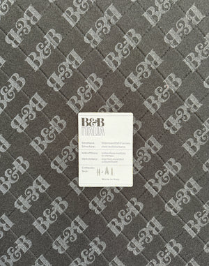 Refurbished graues B&B Italia Tufty Time Designer Stoff Sofa vor einer Wand, stilvoll und modern eingerichtet.