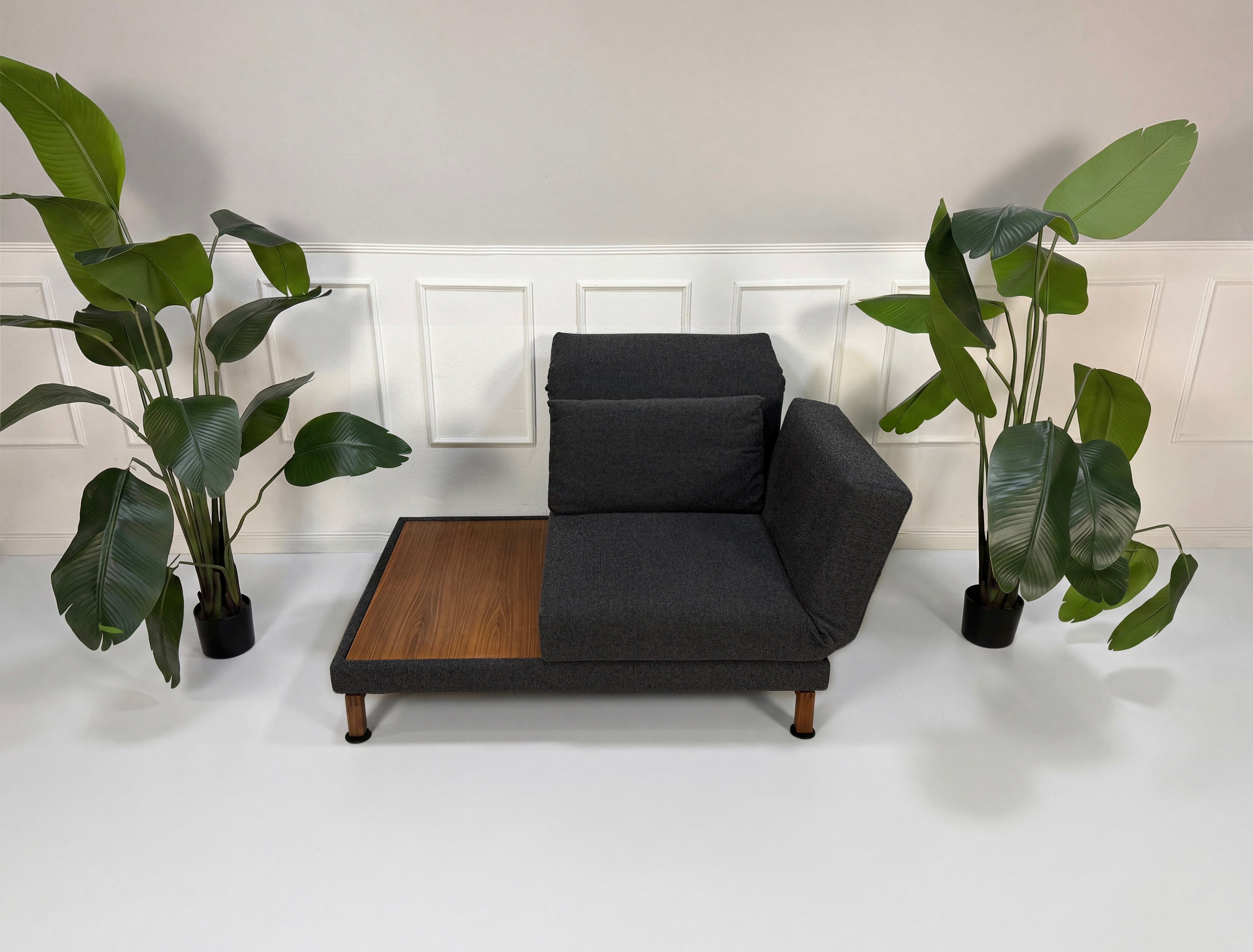 Gebrauchter Brühl Moule Designer Stoff Sessel vor einer Wand, stilvoll und modern eingerichtet.