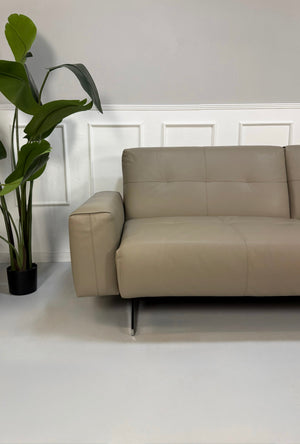Gebrauchtes graues Rolf Benz 50 Designer Leder Sofa vor einer Wand, stilvoll und modern eingerichtet.