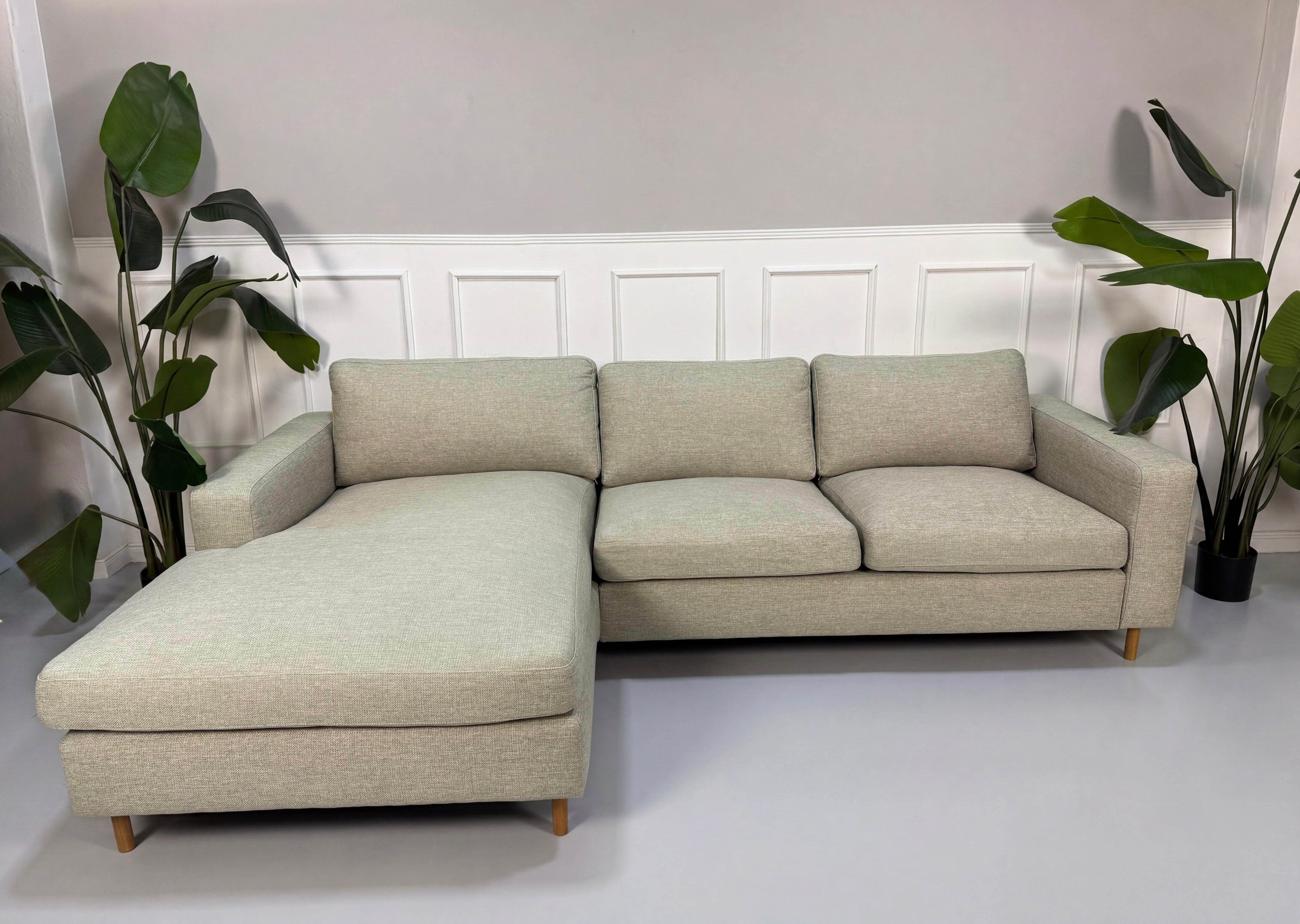 Gebrauchtes grau sand Bolia Scandinavia Designer Stoff Sofa vor einer Wand, stilvoll und modern eingerichtet.
