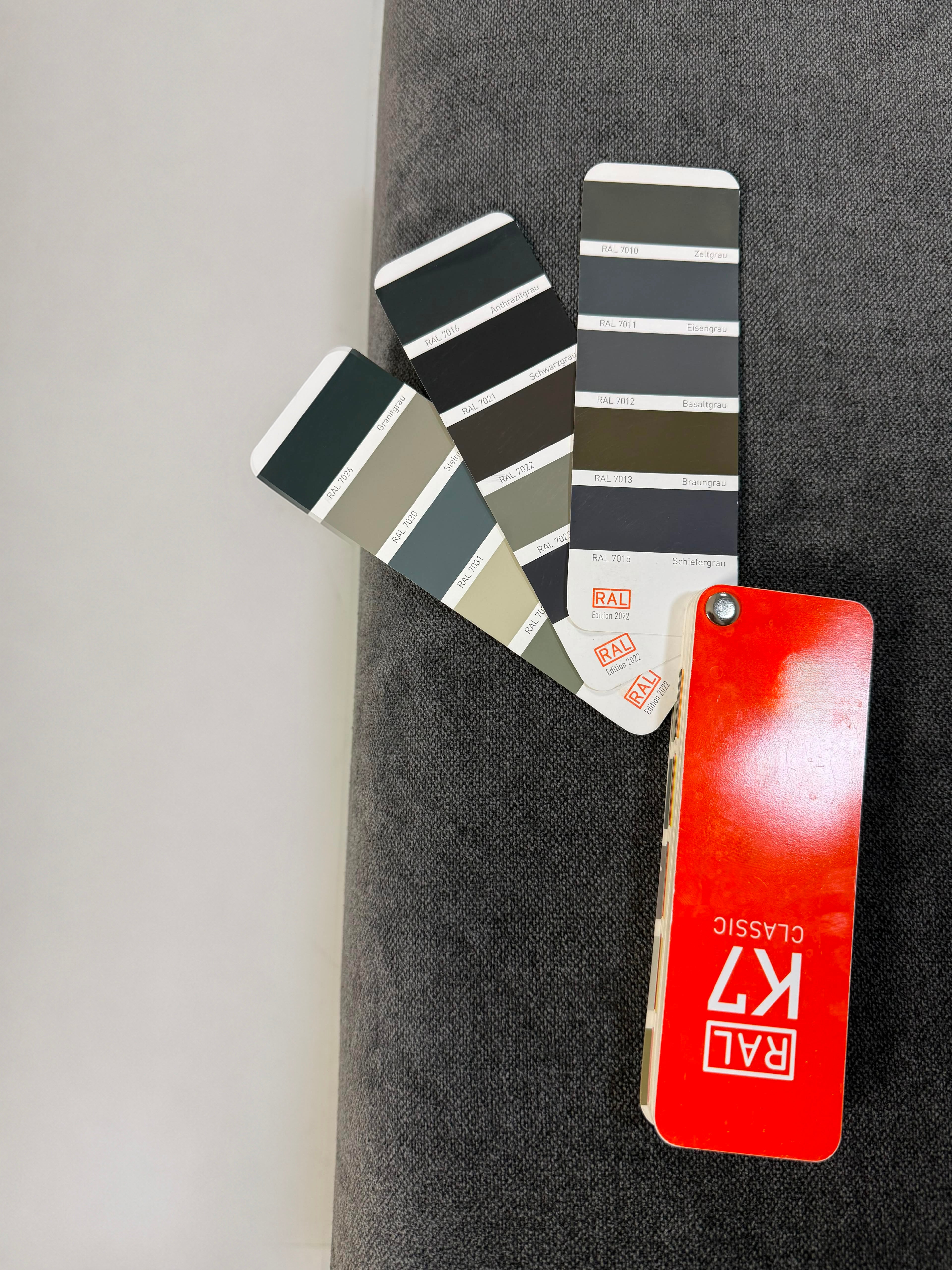 Ausstellungsstück Brühl Moule Designer Stoff Sofa in Grau vor einer Wand, stilvoll und modern eingerichtet.
