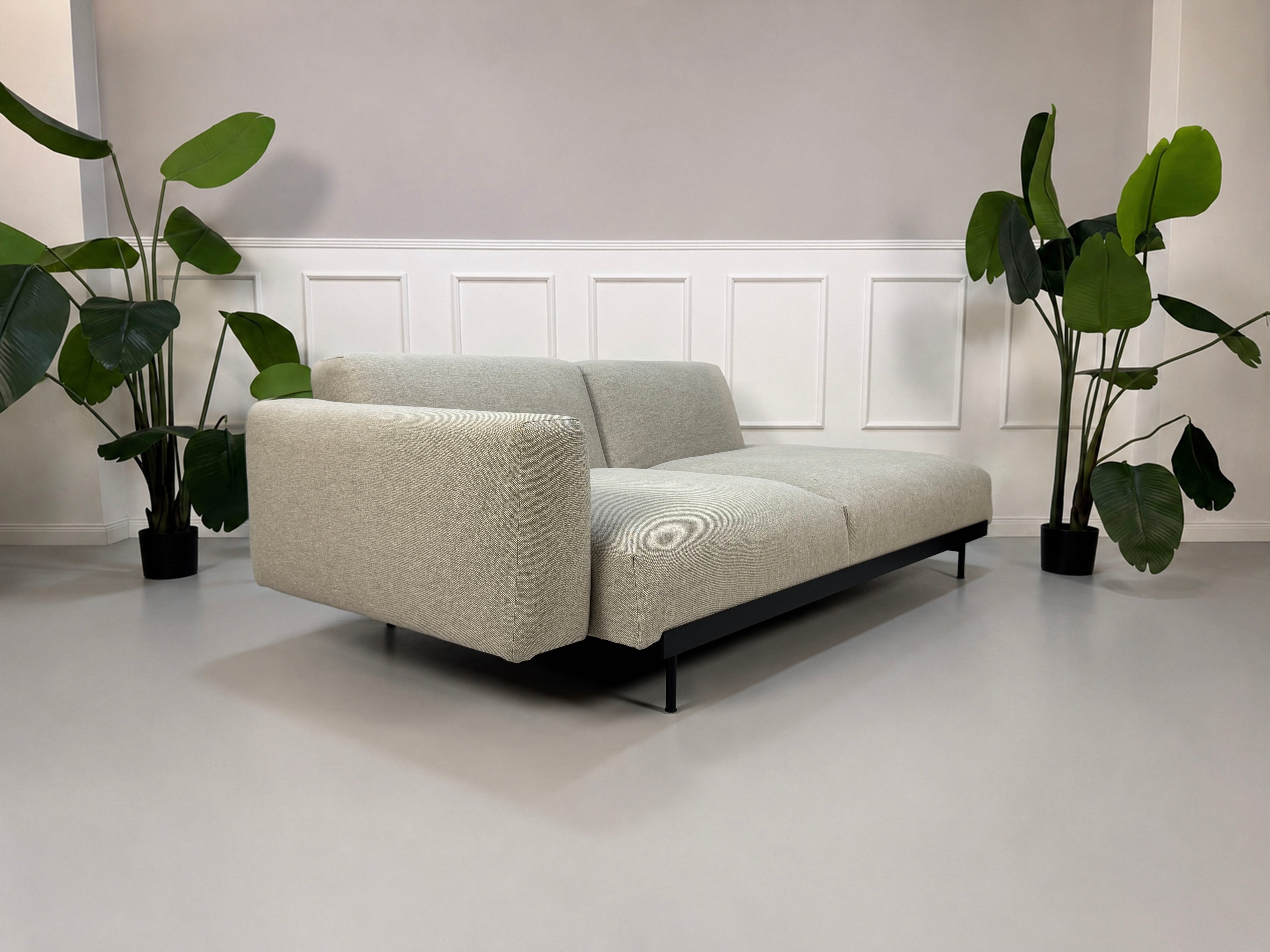 Gebrauchtes grau beiges Muuto In Situ Designer Stoff Sofa vor einer Wand, stilvoll und modern eingerichtet.
