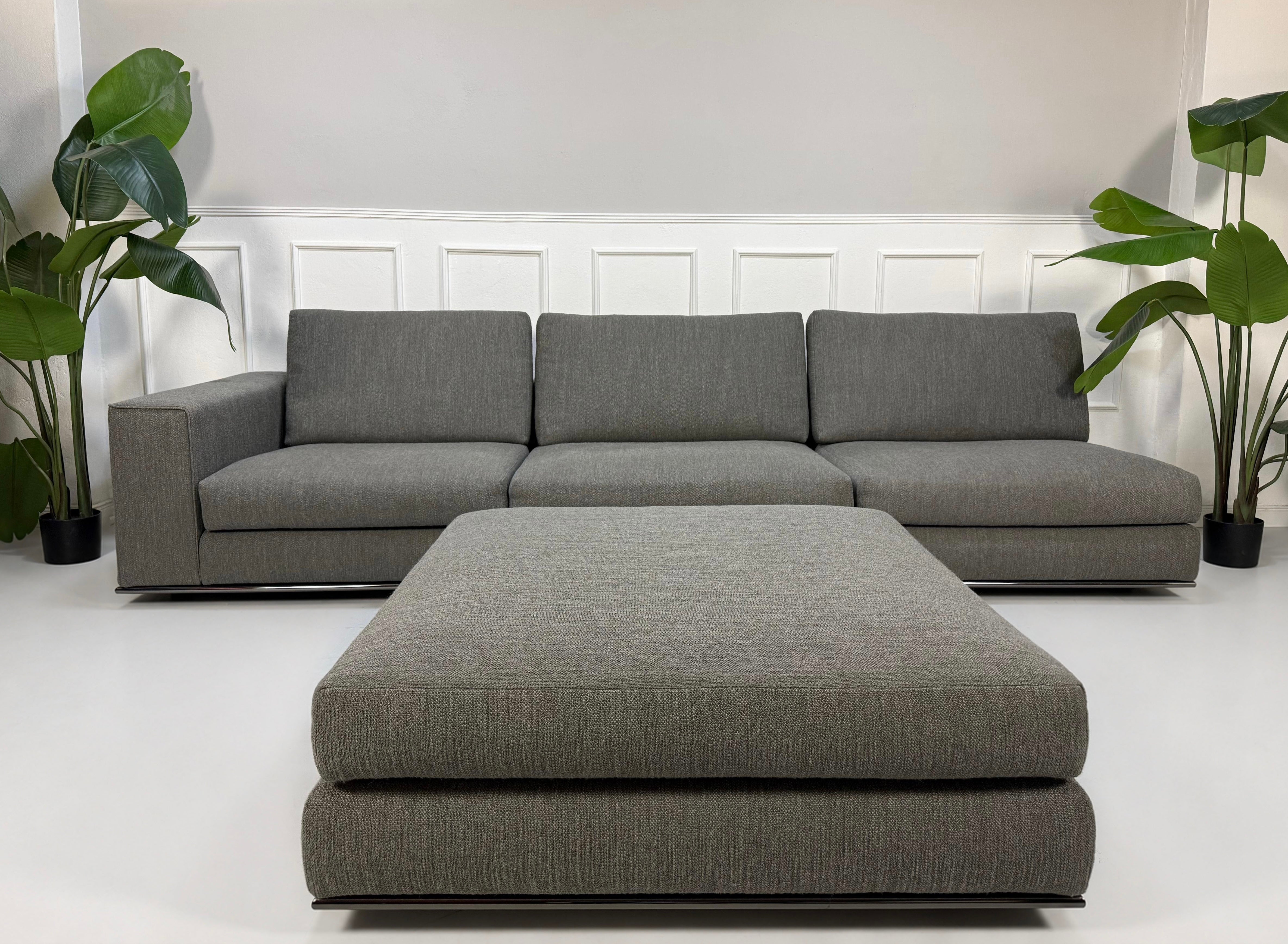 Ausstellungsstück Minotti Hamilton  Designer Stoff Sofa vor einer Wand, stilvoll und modern eingerichtet.