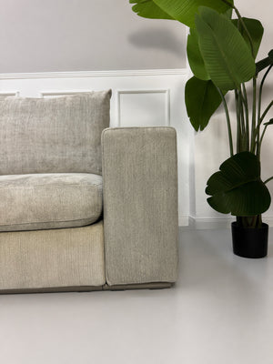 Gebrauchtes graues Flexform Groundpiece Designer Stoff Sofa vor einer Wand, stilvoll und modern eingerichtet.