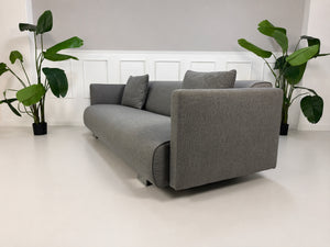 Gebrauchtes graues Rolf Benz 6300 Designer Stoff Sofa vor einer Wand, stilvoll und modern eingerichtet.