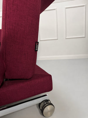 Gebrauchtes rotes Brühl Moule Designer Stoff Sofa vor einer Wand, stilvoll und modern eingerichtet.