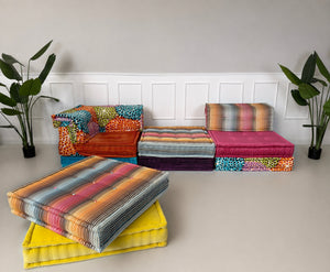 Gestreiftes Missoni Sitzkissen auf gelbem Basiselement des Roche Bobois Mah Jong Modulsofas.