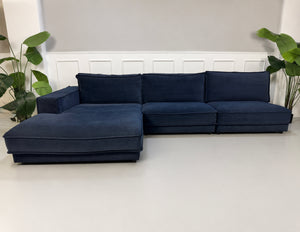 Gebrauchtes blaues Bolia Noora Designer Stoff Sofa vor einer Wand, stilvoll und modern eingerichtet.
