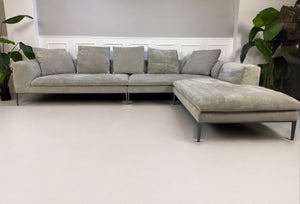 Gebrauchtes graues B&B Italia Michel Designer Stoff Sofa vor einer Wand, stilvoll und modern eingerichtet.