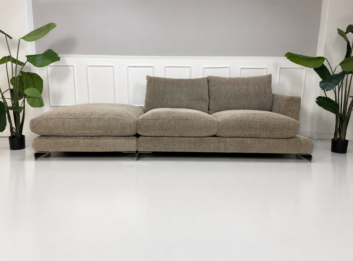 Gebrauchtes beiges Flexform Long Island 05 Designer Stoff Sofa mit Hocker vor einer Wand, stilvoll und modern eingerichtet.