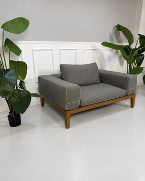 Gebrauchtes graues Flexform Lifewood Designer Stoff Sofa mit Love Chair vor einer Wand, stilvoll und modern eingerichtet.