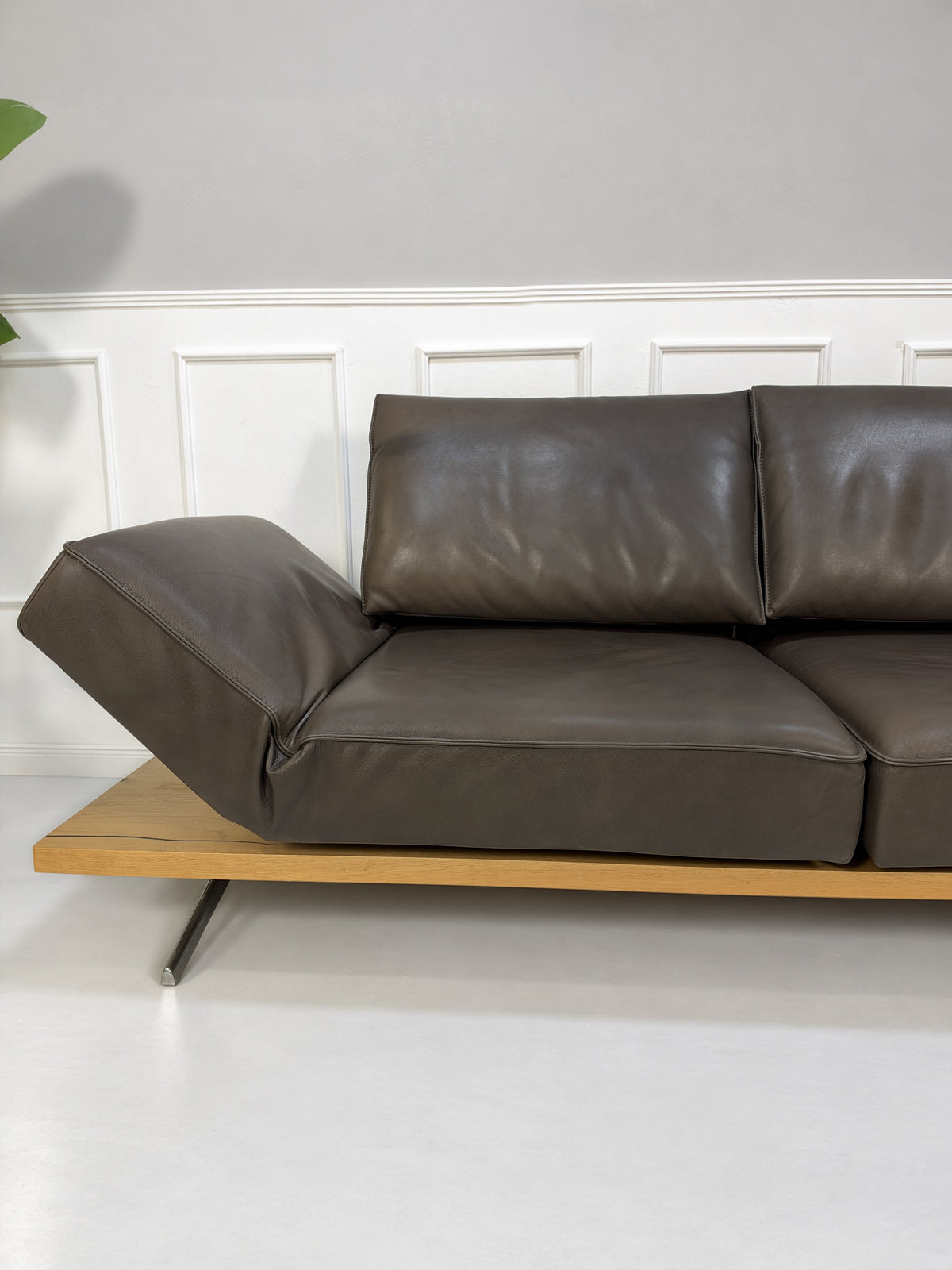 Gebrauchtes braunes Koinor Phoenix Designer Leder Sofa vor einer Wand, stilvoll und modern eingerichtet.