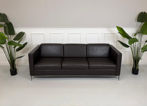 Gebrauchtes braunes Walter Knoll Foster Designer Leder Sofa vor einer Wand, stilvoll und modern eingerichtet.
