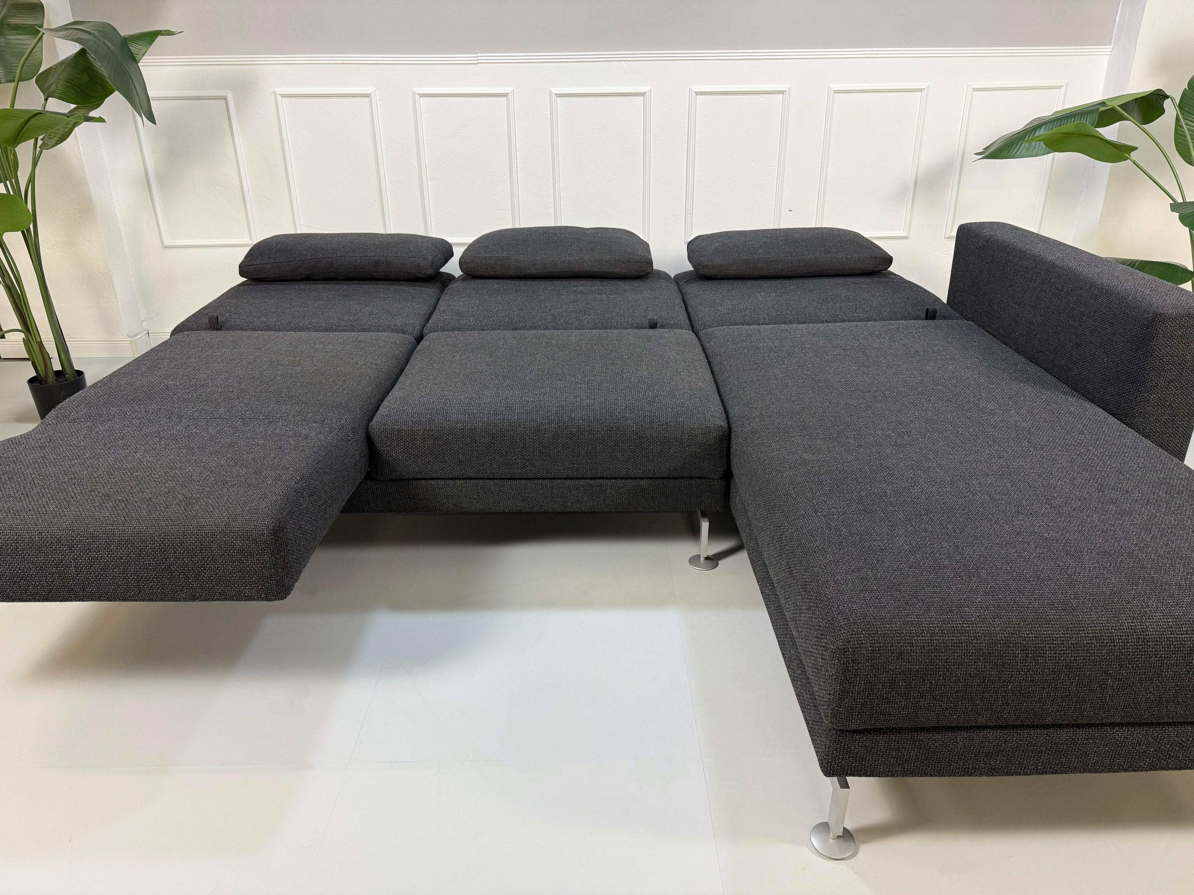 Gebrauchtes Brühl Moule in der Farbe Grau Designer Leder Sofa vor einer Wand, stilvoll und modern eingerichtet.