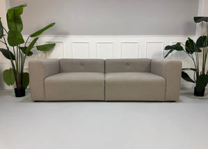 Gebrauchtes graues HAY Mags Designer Stoff Sofa vor einer Wand, stilvoll und modern eingerichtet.