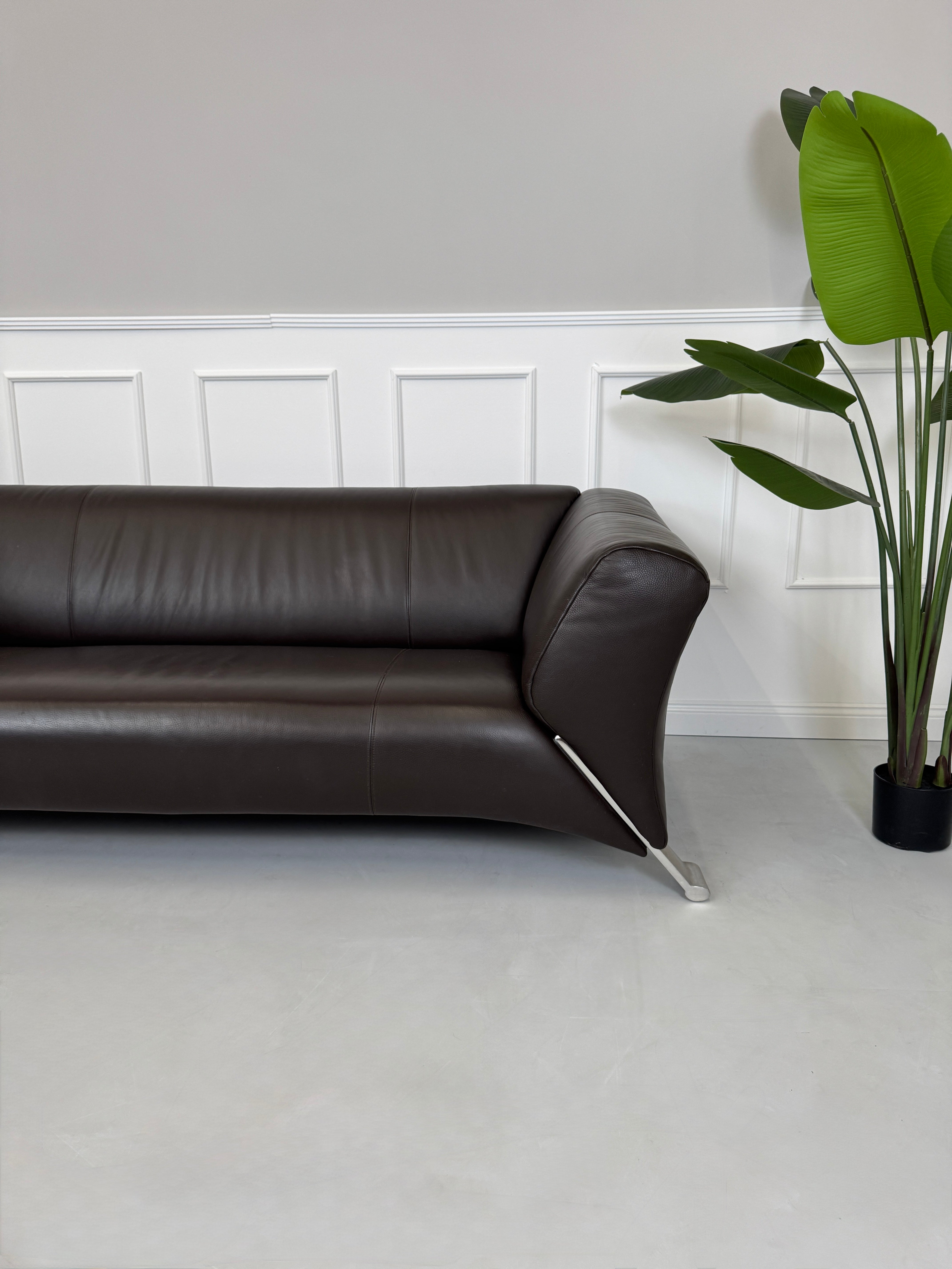 Gebrauchtes braunes Rolf Benz 322 Designer Leder Sofa vor einer Wand, stilvoll und modern eingerichtet.