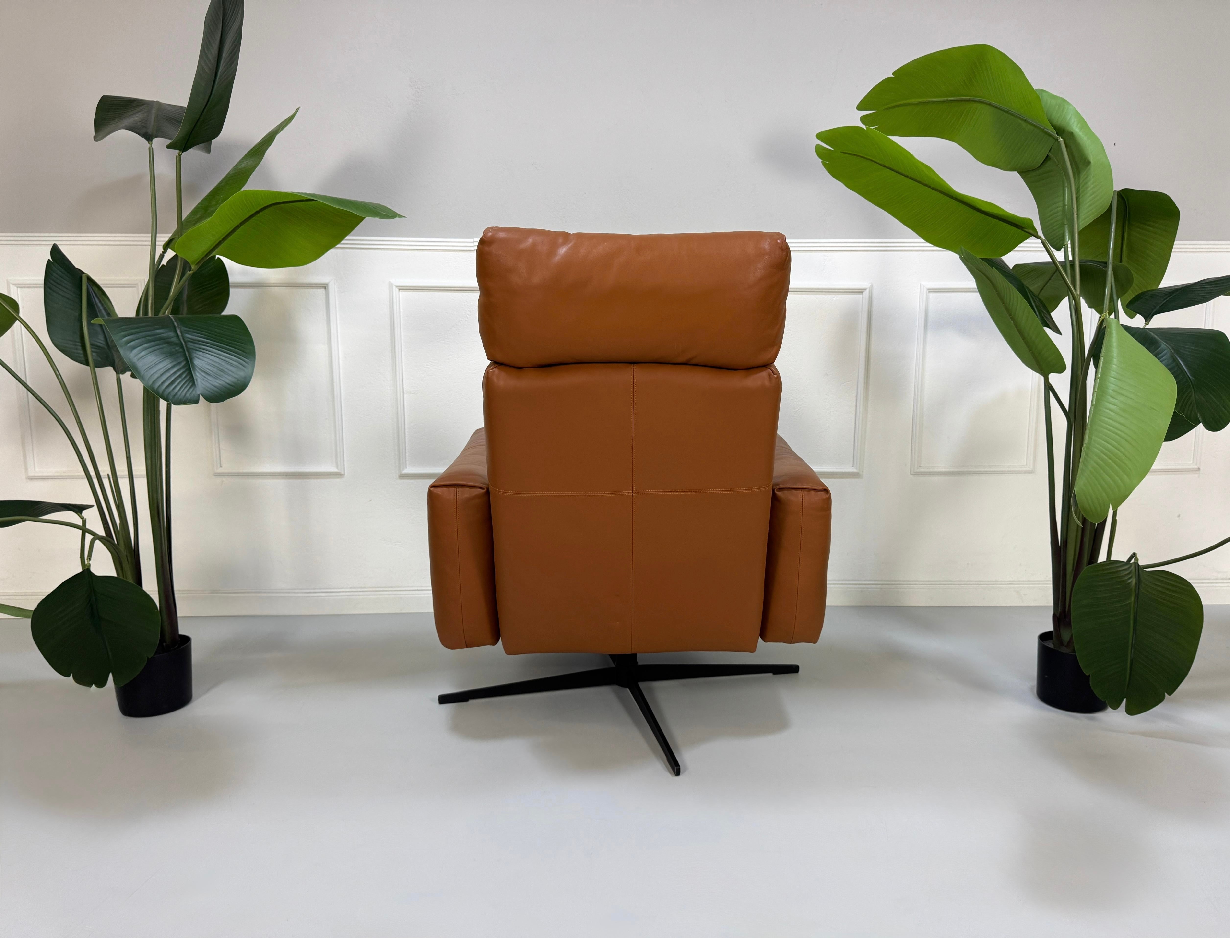 Gebrauchter brauner Rolf Benz 50 Designer Leder Sessel vor einer Wand, stilvoll und modern eingerichtet.