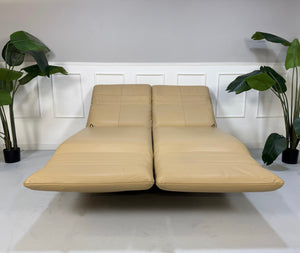 Gebrauchtes beiges Rolf Benz Plura Designer Leder Sofa vor einer Wand, stilvoll und modern eingerichtet.