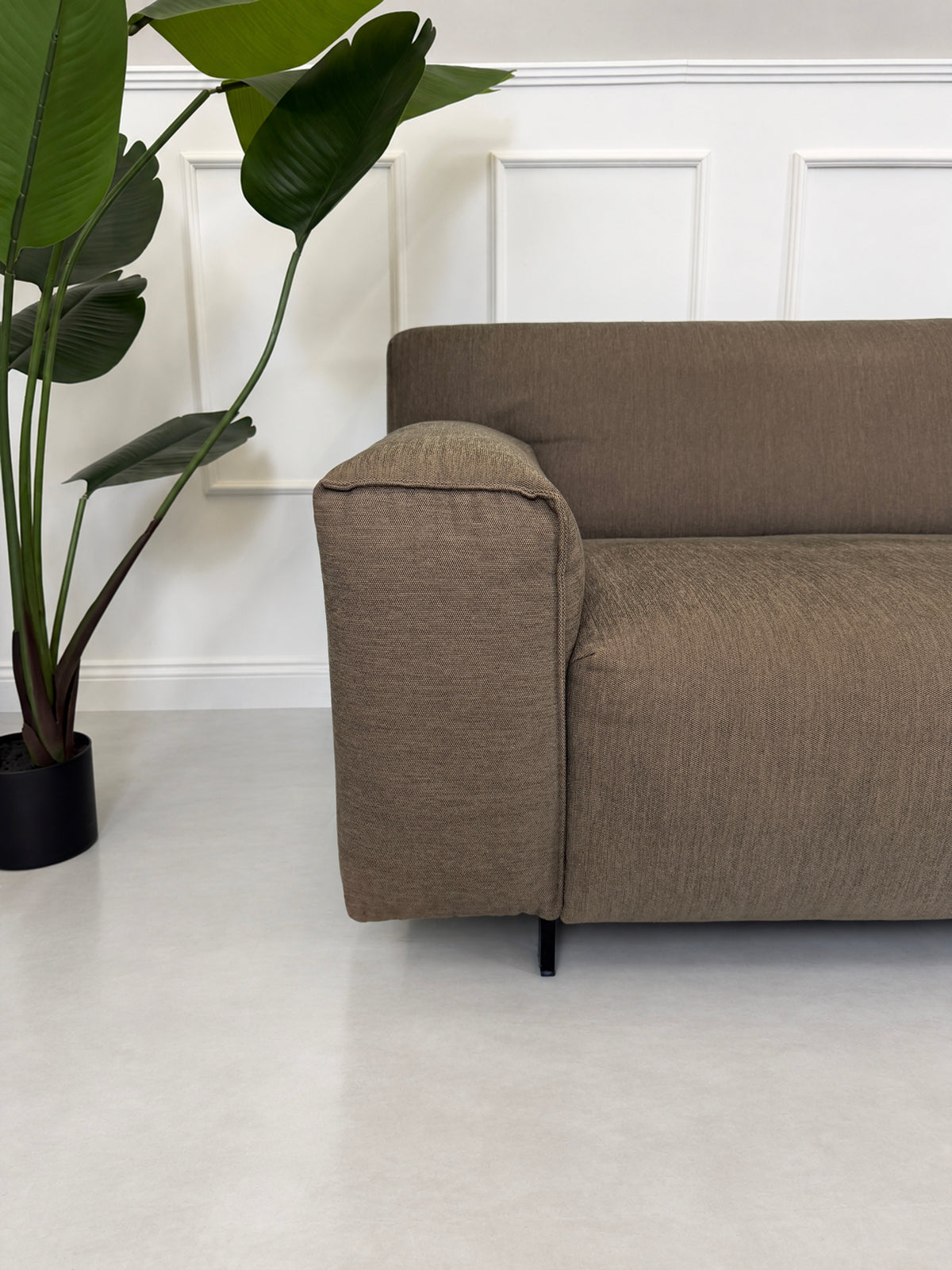 Gebrauchtes braunes Rolf Benz Grata Designer Stoff Ecksofa vor einer Wand, stilvoll und modern eingerichtet.