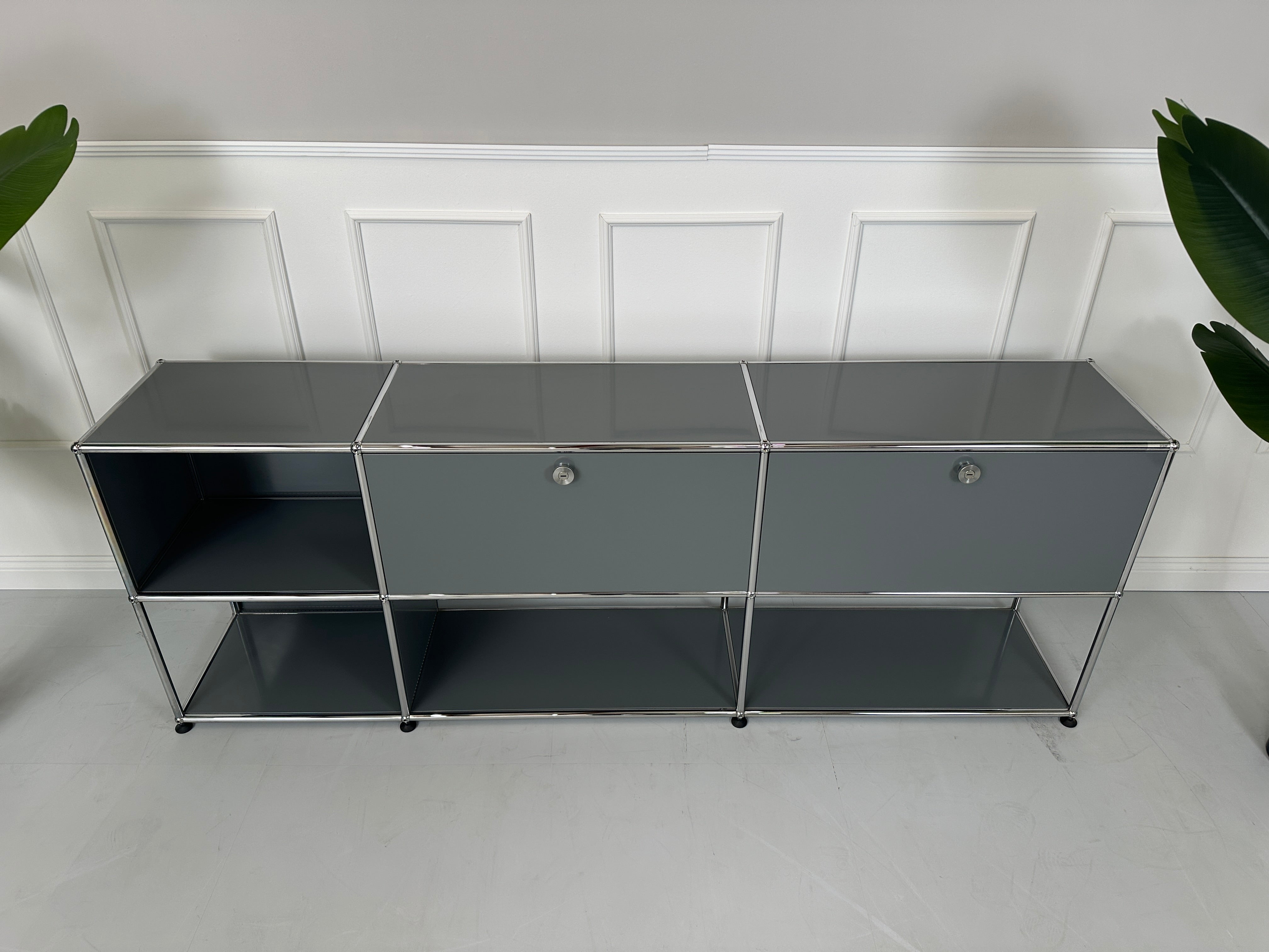 Gebrauchtes USM Haller Sideboard Regal in der Farbe Grau vor einer Wand, stilvoll und modern eingerichtet.